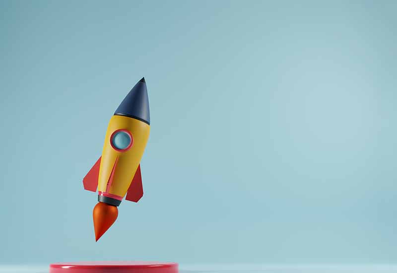 Launched rocket with copy space for text on blue background.