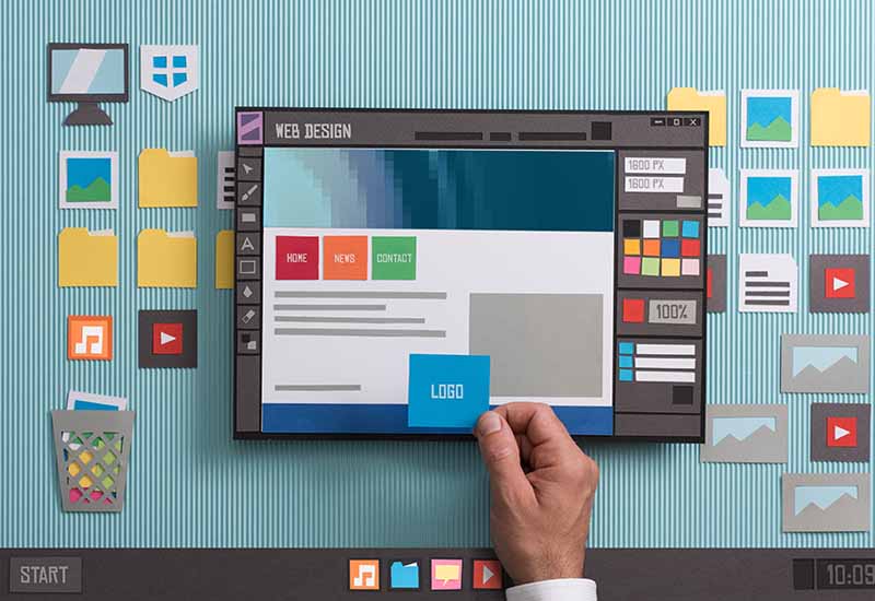 Web designer drafting web templates and web page layouts using a professional software, collage and paper cut composition