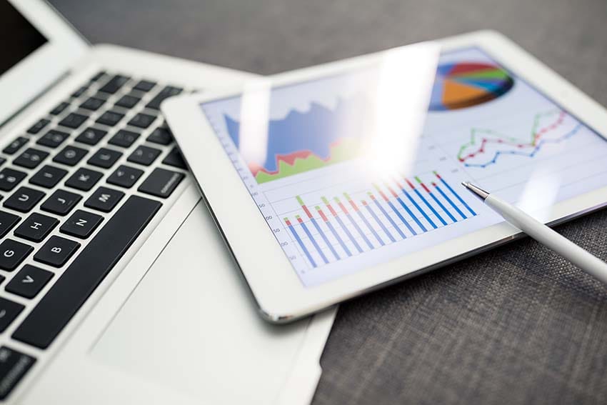 Business charts and diagrams on digital tablet